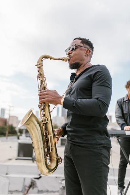 Talented saxophonist passionately playing music outdoors with a city backdrop.