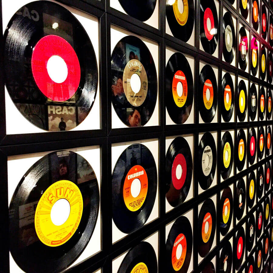 Colorful vinyl records framed and displayed on a wall, showcasing a retro music theme.